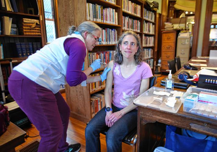 Meg Ryan, a public health nurse with the Franklin Regional Council of Governments, gives Ashfield resident Talia Miller a flu shot during a health clinic at Griswold Memorial Library in Colrain on Wednesday. Thursday, Nov. 16 marks National Rural Health Day.