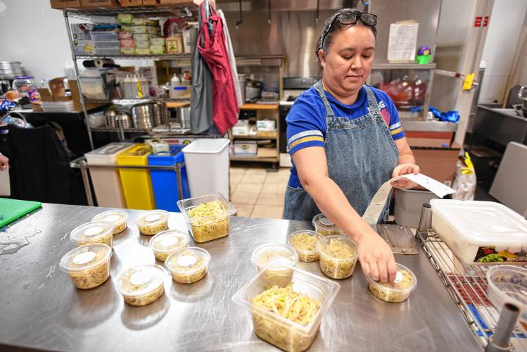 Owner Hilda Bailey packages up bean sprouts at Banchan Korean Deli in Sunderland.