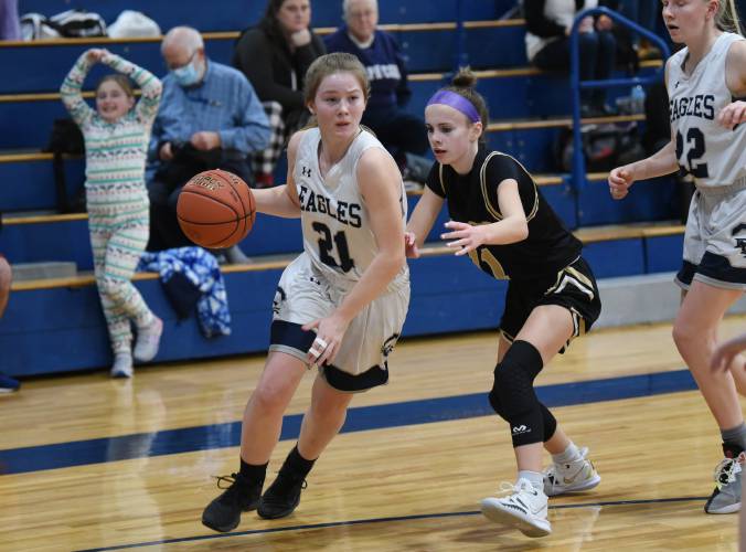 Franklin Tech's Hannah Gilbert (21) drives past Pioneer's Kyler McLellend (11) during a past game. 
