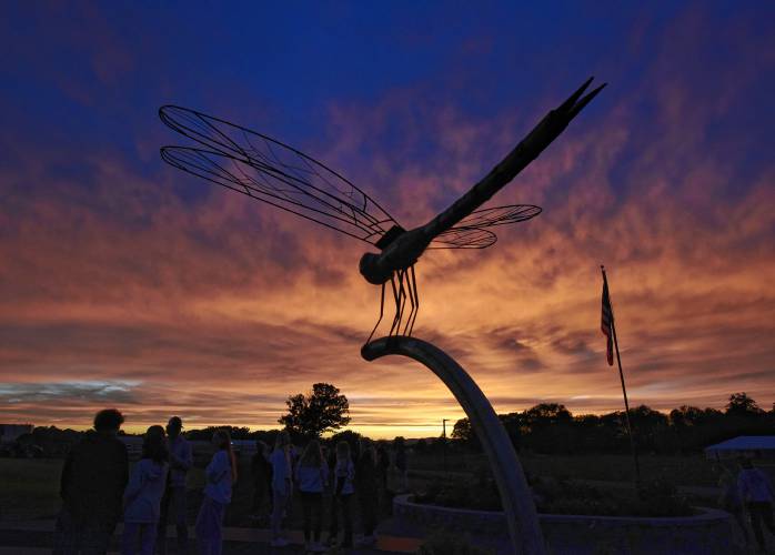 The dragonfly sculpture at the Franklin County Technical School sports facility is silhouetted against the evening sky on Friday night in Montague. The large metal sculpture was created by graduate Emily Whitney as her senior project under the guidance of instructor Lorin Burrows in the welding department.
