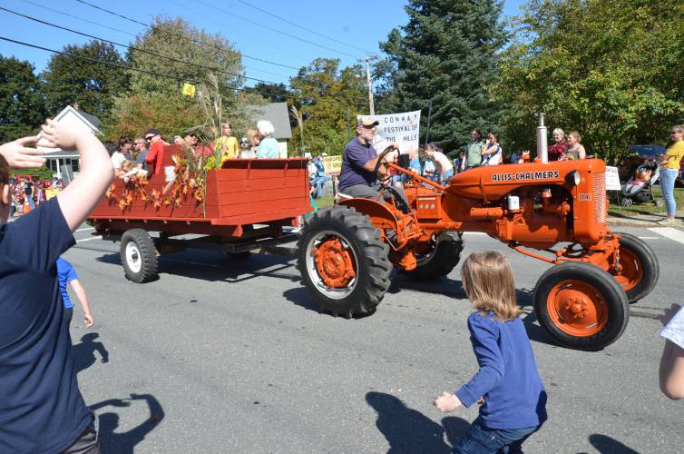 Children throw candy from a tractor during the parade for Conway’s 59th Festival of the Hills on Sunday.