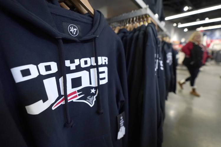 A sweatshirt, left, with a phrase frequently attributed to New England Patriots head coach Bill Belichick, hangs on a rack, Thursday, Jan. 11, 2024, at the Patriots ProShop in Foxborough, Mass. Six-time NFL champion Bill Belichick has agreed to part ways as the coach of the New England Patriots on Thursday, bringing an end to his 24-year tenure as the architect of the most decorated dynasty of the league's Super Bowl era, a source told the Associated Press on the condition of...