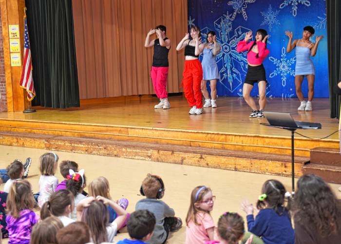One of two groups of students from the University of Massachusetts Amherst perform a K-pop dance number for students at Buckland-Shelburne Elementary School during an all-school assembly on Wednesday. The school has a student, Hajun Sung, from South Korea. His mother, Hyunju Kang, who is a student at UMass, gave a talk introducing their country’s culture and language to the students. 