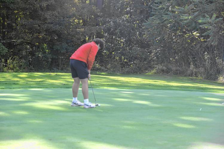 Athol’s Ethan Heuer putts on Hole No. 2 during a match against Greenfield at the Country Club of Greenfield on Wednesday.
