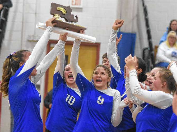 The Turners Falls volleyball team celebrates with a Final Four trophy after a 3-0 sweep of Hopedale in the MIAA Division 5 quarterfinal round on Thursday in Turners Falls.