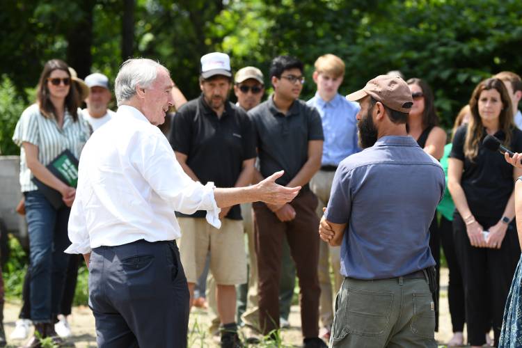 U.S. Sen. Ed Markey talks with David Fisher of Natural Roots farm in Conway in August about his flooded fields.