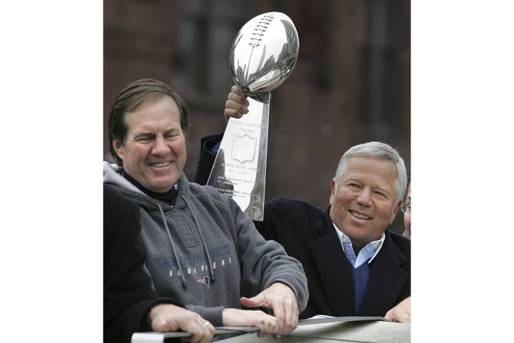 FILE - New England Patriots head coach Bill Belichick, left, smiles as team owner Robert Kraft holds up the Vince Lombardi trophy during a Super Bowl victory parade in Boston, Tuesday, Feb . 8, 2005. The Patriots beat the Philadelphia Eagles 24-21 in Super Bowl XXXIX. Six-time NFL champion Bill Belichick has agreed to part ways as the coach of the New England Patriots on Thursday, Jan. 11, 2024, bringing an end to his 24-year tenure as the architect of the most decorated dynasty of...