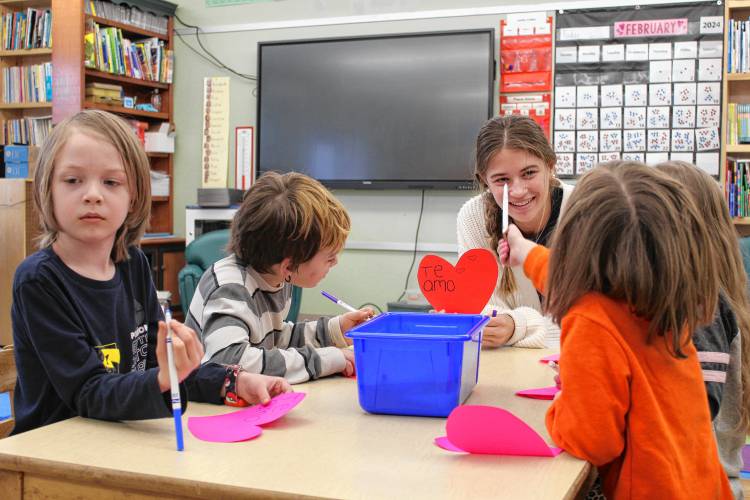 During a biweekly visit to the Conway Grammar School, Deerfield Academy junior Alex Hermsdorf teaches kindergartners how to say “I love you” in Spanish, along with other lessons.
