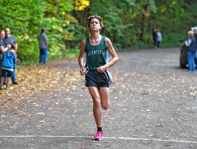 Greenfield’s Jackson Caron crosses the finish line second overall at Highland Park on Tuesday afternoon. 