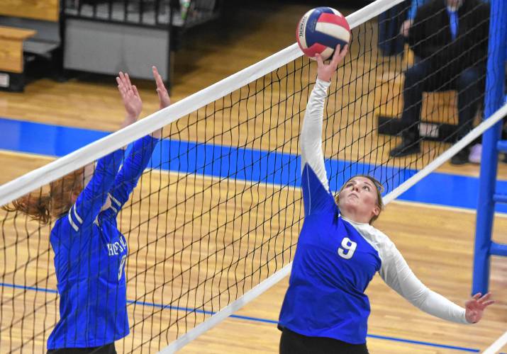 Turners Falls’ Taylor Greene (9), right, tips the ball over Hopedale blocker Maddy Buttonnow (9) at the net in the third set of a 3-0 sweep of Hopedale in the MIAA Division 5 quarterfinal round on Thursday in Turners Falls.