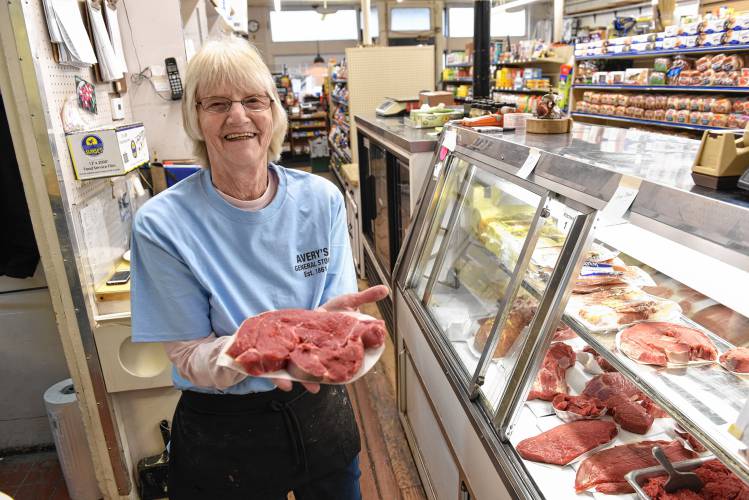 Paula Rice holds a boneless sirloin behind the meat counter at Avery’s General Store in Charlemont.