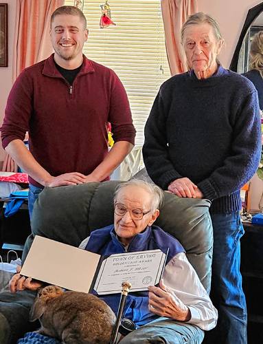 Erving’s Boston Post golden cane recipient Robert Bitzer poses for a photo with Town Administrator Bryan Smith (at left) and Golden Cane Committee Chair David Brule in his Lillians Way home. The golden cane is bestowed to a town’s oldest resident.