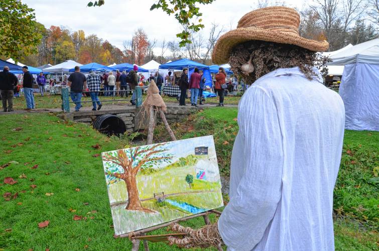 Melinda Cross’ scarecrow paints the scene of the 19th annual Scarecrow in the Park festival at Cushman Park in Bernardston.