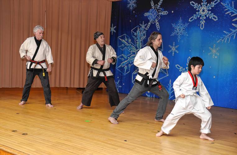 Buckland-Shelburne Elementary School student Hajun Sung, right, who is from South Korea, performs with other members of Ashfield Tae Kwon Do during an all-school assembly on Wednesday featuring all things South Korean. The celebration was intended for others to learn more about the culture of his native homeland and to help him share his sense of pride with others.