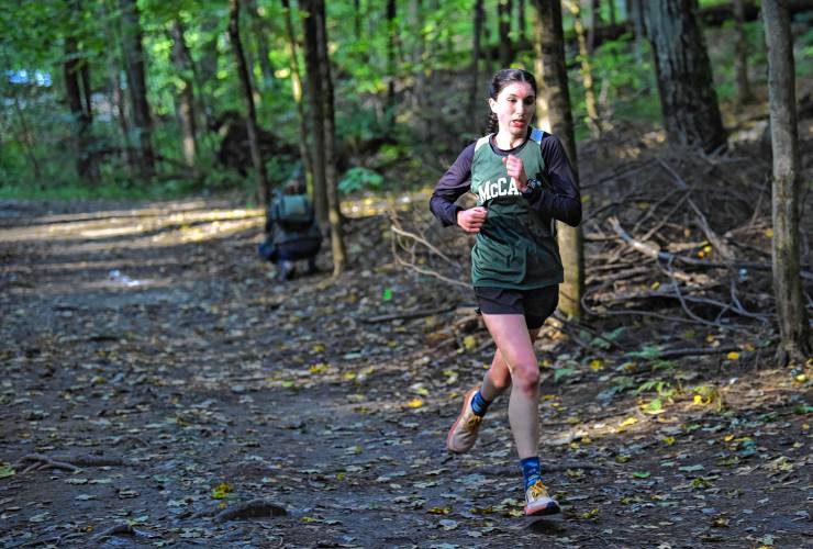 Eventual girls winner Camryn Moran of McCann Tech enters the woods at Highland Park on Tuesday afternoon. 