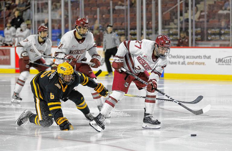 UMass forward Michael Cameron (27) gets past AIC defender Matt Rickard (6) for a breakaway goal in the third period Saturday night at the Mullins Center in Amherst.