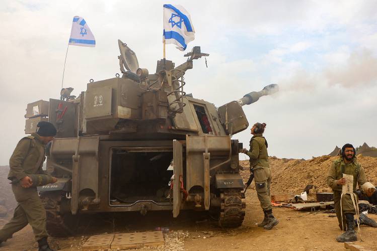 An Israeli artillery unit is pictured near the border with the Gaza Strip on Tuesday amid continuing battles between Israel and the militant group Hamas.