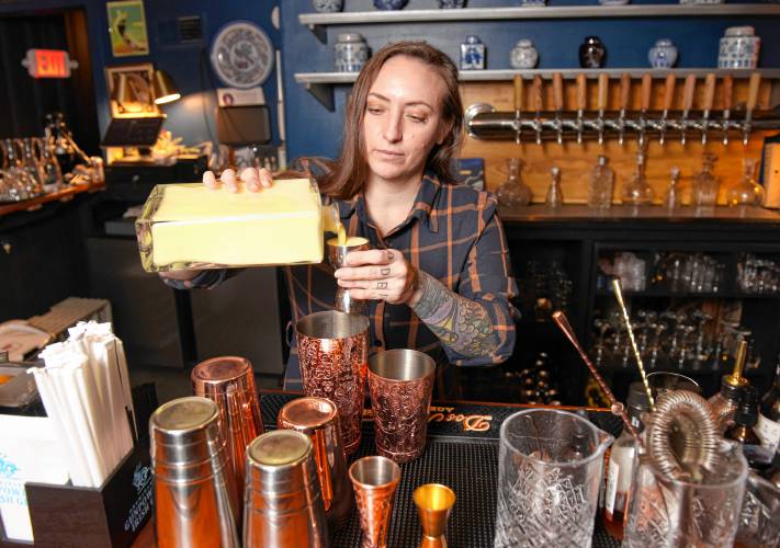 Bar manager Mariel Olcoz makes a Smoked Eggnog cocktail with housemade eggnog at Le Peacock in Shelburne Falls. 
