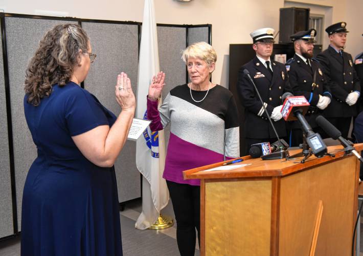 Greenfield City Clerk Kathy Scott administers the oath of office to new Greenfield Mayor Virginia “Ginny” Desorgher at the John Zon Community Center Tuesday morning. 