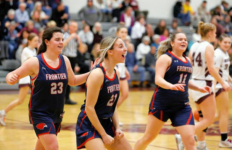 Frontier players Molly Gates (23), from left, Olivia Machon (21) and Claire Kirkendall (11) celebrate as they walk off the court after their 47-39 win against Easthampton on Thursday night in Easthampton.