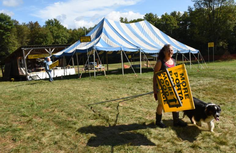 Deb Habib of Seeds of Solidarity Farm helps set up the Garlic Festival grounds in Orange getting ready for the weekend.