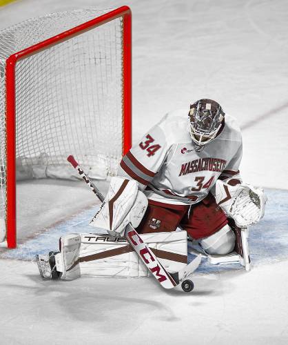 UMass senior goalie Cole Brady (34) makes a save against AIC in the first period earlier this season at the Mullins Center in Amherst.