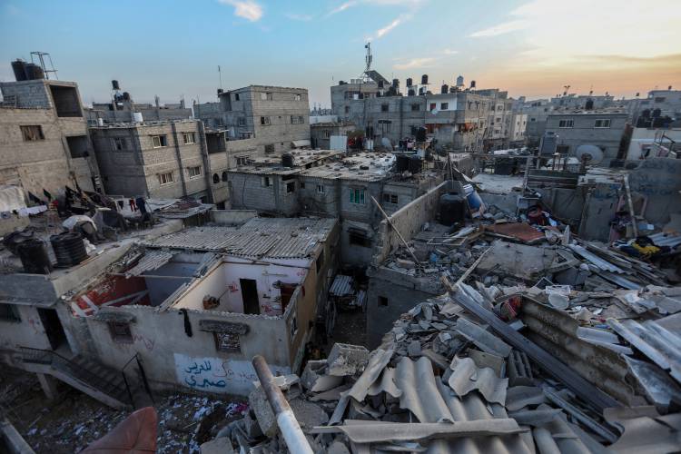 Palestinian citizens inspect the destruction caused by air strikes on their homes on Sunday, Dec. 3, in Khan Yunis, Gaza.