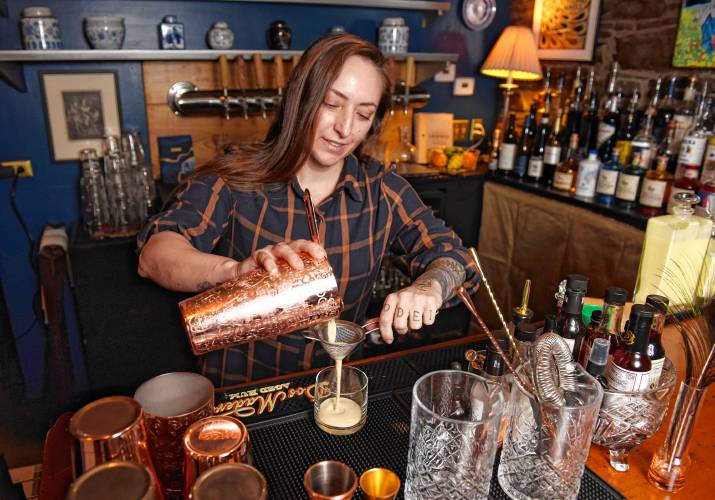 Bar manager Mariel Olcoz makes a Smoked Eggnog cocktail at Le Peacock in Shelburne Falls. 