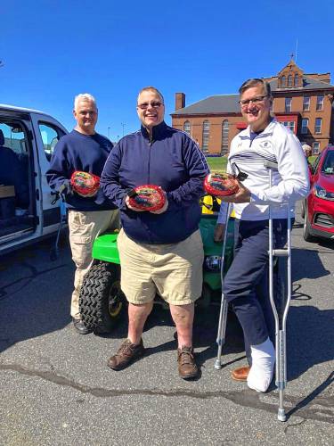 Franklin County TRIAD Officer Ray Zukowski, DJ Robert “Bobby C” Campbell and Franklin County Sheriff Christopher Donelan hold hams donated to area senior centers in 2021. Money is being collected now for the eighth annual Franklin County TRIAD Hams for Seniors fundraiser.