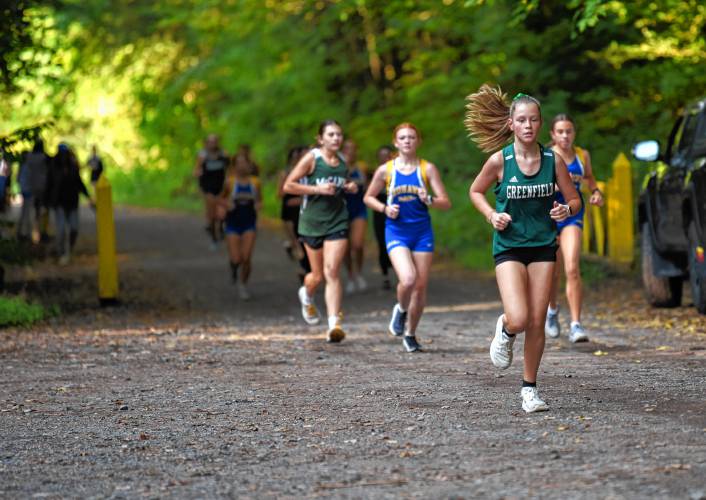 Runners compete during the girls’ race at Highland Park on Tuesday afternoon.