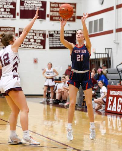 Frontier’s Olivia Machon (21) hits a three-pointer over Easthampton defender Grace Pappadellis (12) in the fourth quarter Thursday night in Easthampton.