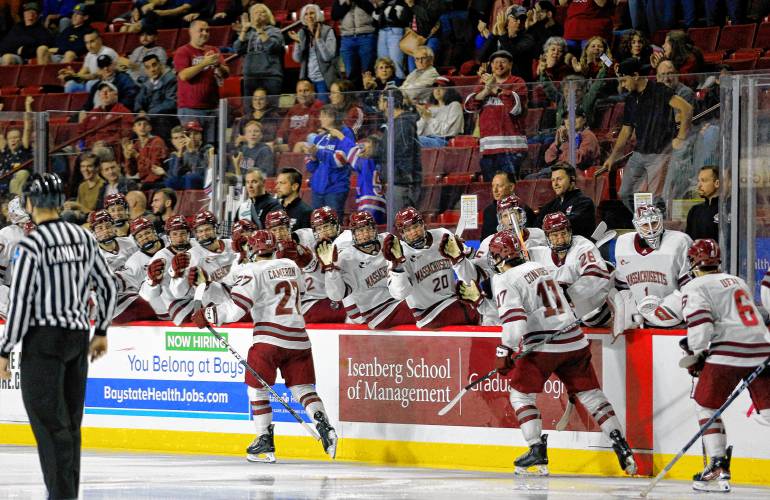 UMass forward Michael Cameron (27) celebrates a third period goal against AIC on Saturday night at the Mullins Center in Amherst.