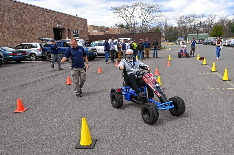 Franklin County Technical School Superintendent Rick Martin wears goggles simulating various types of alcohol and drug impairment as he tries to navigate a course of cones set up for students by School Resource Officer Mike Sevene on Wednesday.